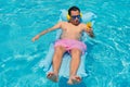 Man sunbathing by the pool and holding cell phone in his hand Royalty Free Stock Photo