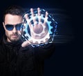 Man in sunglasses controls virtual system by hand. Royalty Free Stock Photo