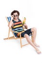 man in sunglasses and hat relaxing on beach chair with cocktail, isolated on white Royalty Free Stock Photo