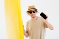 Man in sunglasses holding surfboard and showing blank screen smartphone Royalty Free Stock Photo