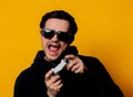 Man sunglasses keen plays with a joystick Royalty Free Stock Photo