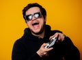 Man sunglasses keen plays with a joystick Royalty Free Stock Photo