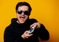 Man sunglasses keen plays with a joystick Royalty Free Stock Photo