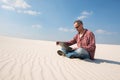 Man in sunglasses is passionate about work, with a laptop in desert Royalty Free Stock Photo