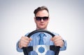 Man in sunglasses in a shirt and tie holds the steering wheel. Front view. Car driver concept