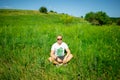 Man in sunglasses sitting on grass with laptop Royalty Free Stock Photo