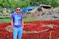 Man in sunglasses standing near the flowers turkish flag in the city park