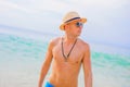 Man in sunglasses and straw hat on the beach Royalty Free Stock Photo