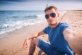 Man in sunglasses taking selfie on a sea beach Royalty Free Stock Photo