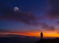 Man at sunset. Hiker in the mountain at sunset with moon Royalty Free Stock Photo