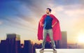 Man in superhero cape over sunset in tokyo city Royalty Free Stock Photo