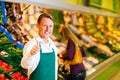 Man in supermarket as shop assistant Royalty Free Stock Photo