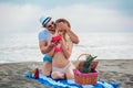 Man suprising his girlfriend with gift on the beach Royalty Free Stock Photo