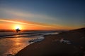 Man with surfboard on the beautiful sunrise beach. Royalty Free Stock Photo