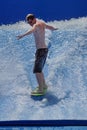 Person on a `flowrider` surf simulator