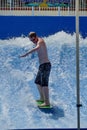 Person on a `flowrider` surf simulator