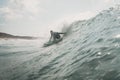 Man surfer on the blue sea with large waves