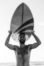 Man surfer carrying his surfboard at sunrise - Hipster male in shirtless waiting for the high waves on beach - Lifestyle and extre Royalty Free Stock Photo