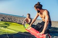 Man surfers with his son in wetsuits with kite equipment Royalty Free Stock Photo