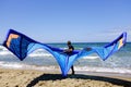 Man surfers in wetsuits with kite equipment for surfing, in Sabaudia, Lazio, Italy