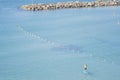 Man surfing on a SUP Standup paddleboarding in the water of the Mediterranean Sea