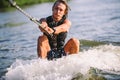 A man is surfing on a surfboard drawn by a motor boat above the wave of the boat. Weixerfer is engaged in surfing, entertainment, Royalty Free Stock Photo