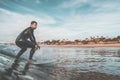 Man surfing a wave near to the coast