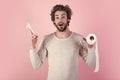 Man with surprised face hold toilet paper. Pandemic. Man in underwear with disheveled hair, morning. Sterility and Royalty Free Stock Photo