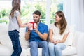 Man surprised with gift from daughter Royalty Free Stock Photo