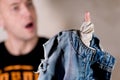 A man is surprised at the hole in his jeans pocket that he discovered Royalty Free Stock Photo