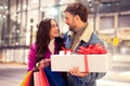 man surprises girlfriend with Valentine's gift during holiday shopping outdoors