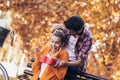 Man surprises woman with a gift in the park Royalty Free Stock Photo