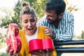 Man Surprises woman With Gift in the park Royalty Free Stock Photo