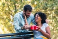 Man Surprises woman With Gift in the park Royalty Free Stock Photo