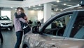 Man Surprising Woman with New Car In Show Room Royalty Free Stock Photo