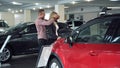 Man Surprising Woman with New Car In Show Room Royalty Free Stock Photo