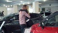 Man Surprising Woman with New Car In Show Room Royalty Free Stock Photo