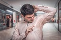 Man with sweating under armpit in shopping center Royalty Free Stock Photo