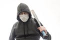 Criminal in a hoodie and mask with a black baseball bat on his shoulder