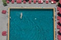 A man swim in the pool at the hotel with red beach umbrella Royalty Free Stock Photo