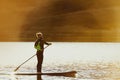 Man swim sup paddle board sunset Royalty Free Stock Photo
