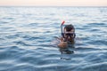 Man swiming in a mask for diving and showing a sign approx Royalty Free Stock Photo