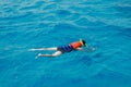 Man swimmer with mask and snorkel is engaged in snorkeling in red sea, turquoise clear water. Concept Travel Egypt Royalty Free Stock Photo