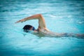 Man swimmer swimming crawl in a blue water pool Royalty Free Stock Photo