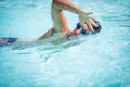 Man swimmer swimming crawl in a blue water pool Royalty Free Stock Photo