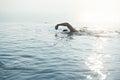 A man swimming for exercise in at swimming pool