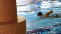 Man Swimming in Pool. Fit young male swimmer training in the pool. Young man swimming the front crawl in a pool. Young