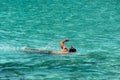 Man swimming and snorkeling with mask in turquoise sea during summer vacation Royalty Free Stock Photo