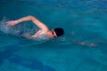 Man swims forward crawl style in swimming pool Royalty Free Stock Photo