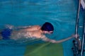 Man swims forward crawl style in swimming pool Royalty Free Stock Photo